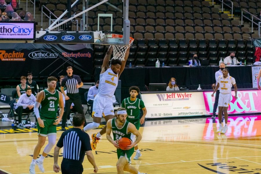 Adrian Nelson (4) finishes off a slam dunk against Wright State on Friday night.