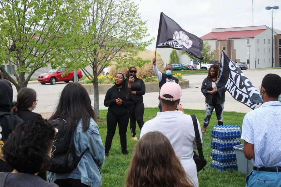 Danielle Polion recites a poem to the crowd outside of Norse Commons.