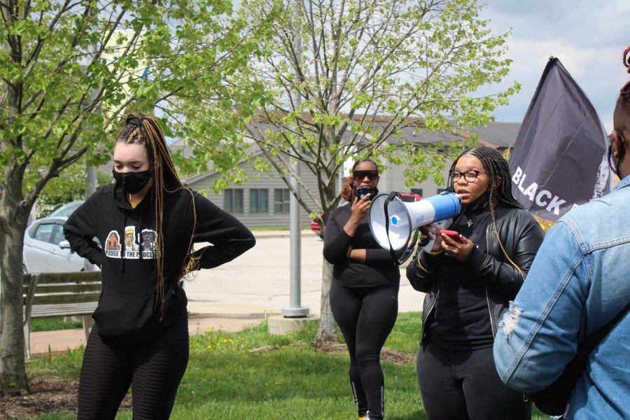 NKU R.O.C.K.S. Vice President Jaelynn Gentry speaks to the crowd by the Housing Rock.