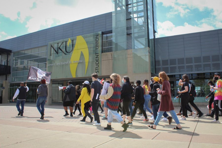 Students march on the SU plaza on the way to the Lucas Administration Center.
