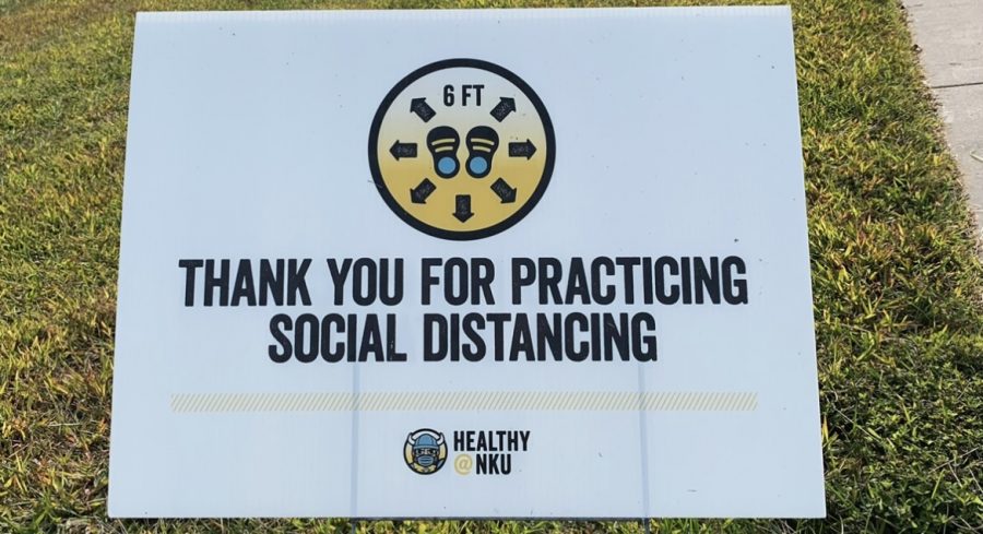 “Thank you for practicing social distancing” sign in front of the Rec Center on campus in the grass.