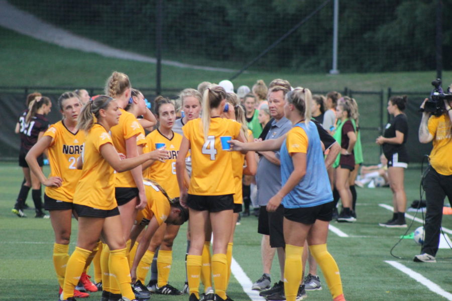 The NKU womens soccer huddles on the sideline for a water break during a match against Eastern Kentucky.