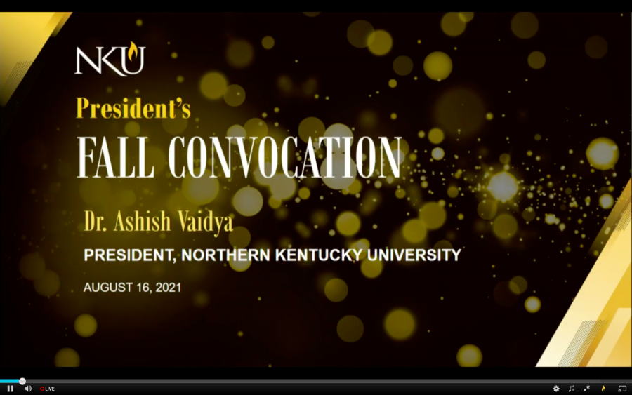 NKU Fall Convocation screen, black and gold with spots all around