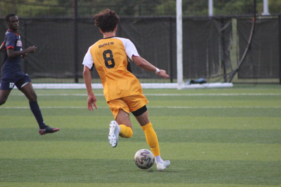 NKU sophomore Roberto Burlew (8) dribbles in the open field against Robert Morris on Saturday.