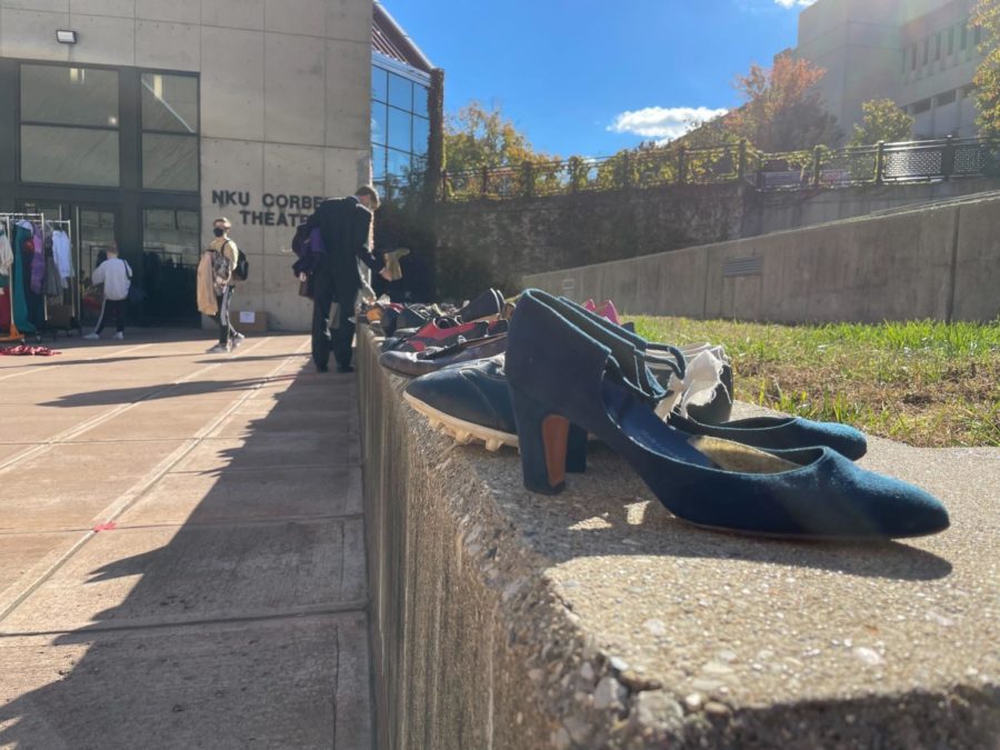 Line of shoes for sale on the steps outside the Corbett Theatre.