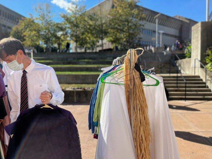 A shopper and rack of costumes for sale.