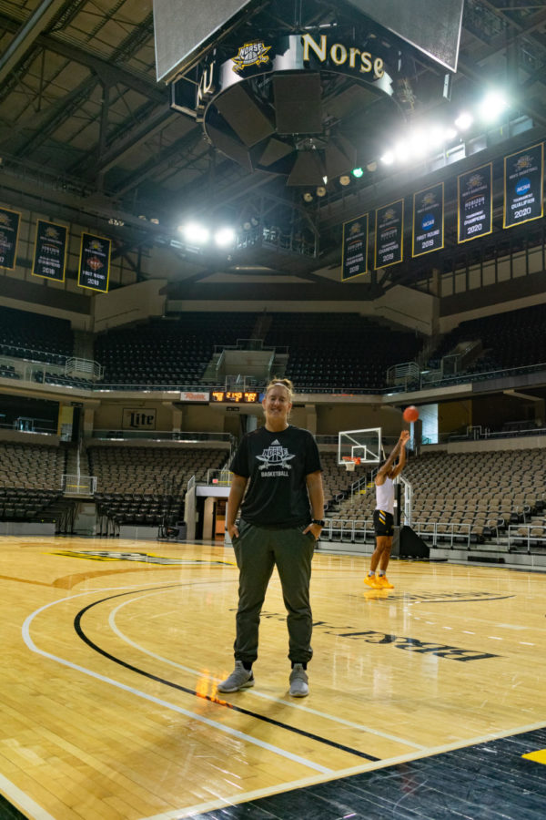 Molly Glick poses for a picture on the court at BB&T Arena. Glick is preparing for her first season as womens basketball Director of Operations.