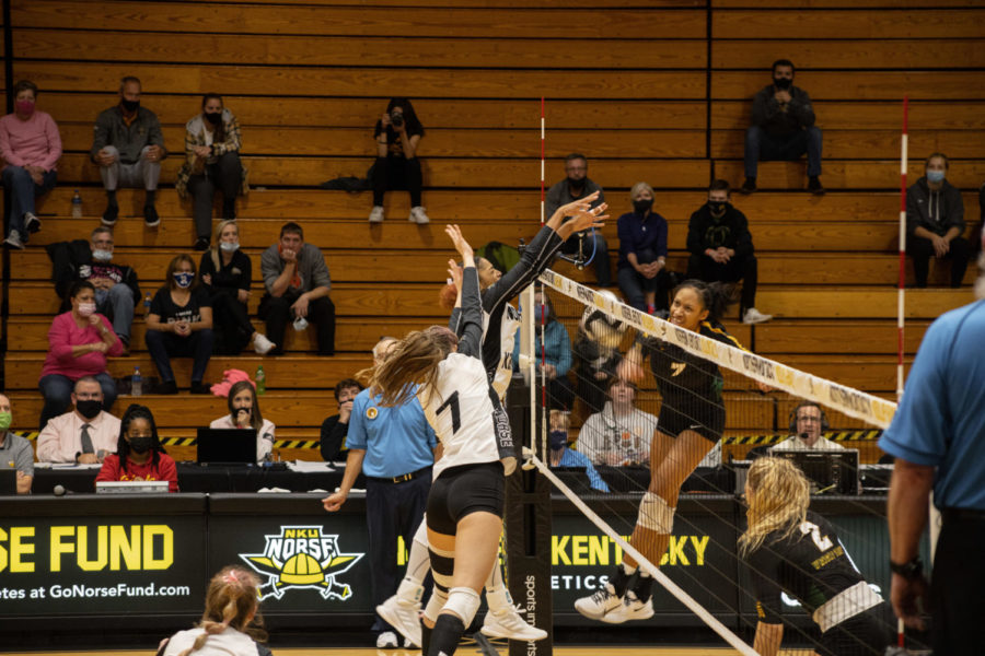 Two NKU volleyball players leap at the net along with a Wright State player during the Raiders 3-2 win on Friday.