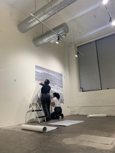 Kang installing pieces in an exhibition she curated titled, “In Regards to Nostalgia”
