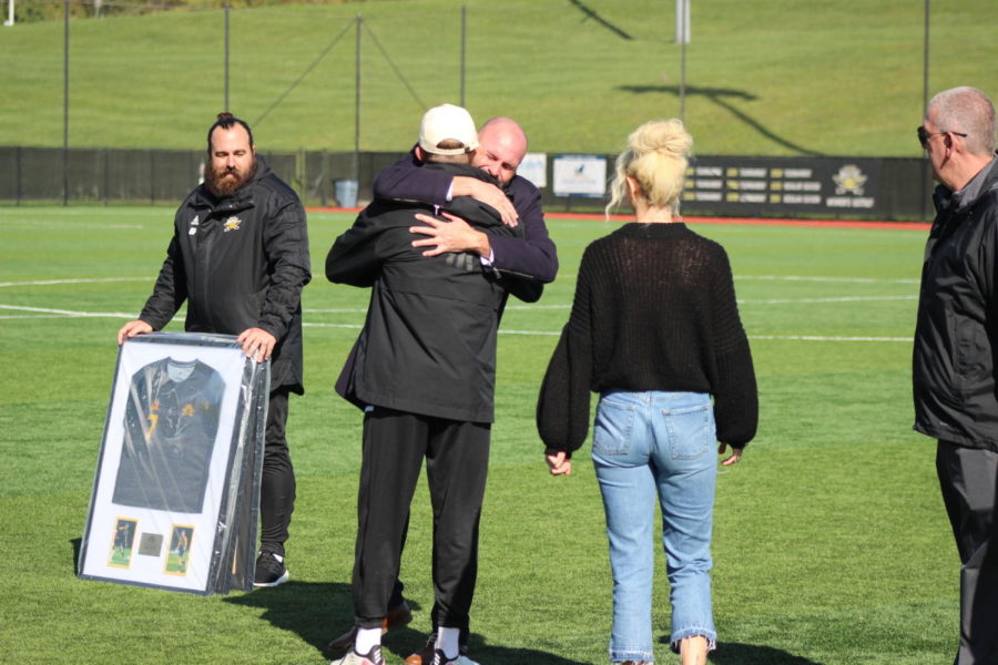 NKU head coach Stu Riddle and forward Dylan Bufton embrace during the pregame Senior Day festivities on Wednesday.