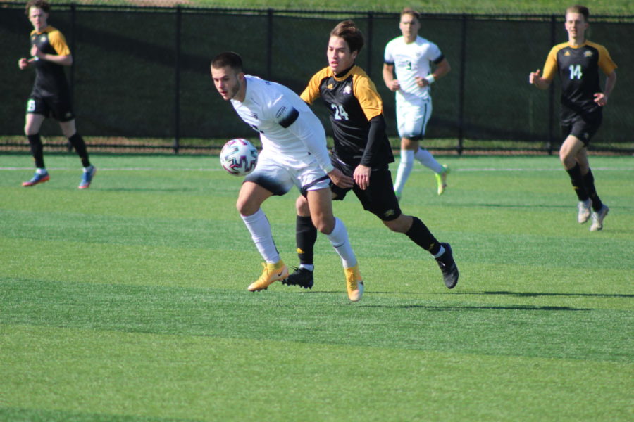 NKUs Daniel Kaufman (24) goes after the ball along with an Oakland player on Wednesday afternoon.