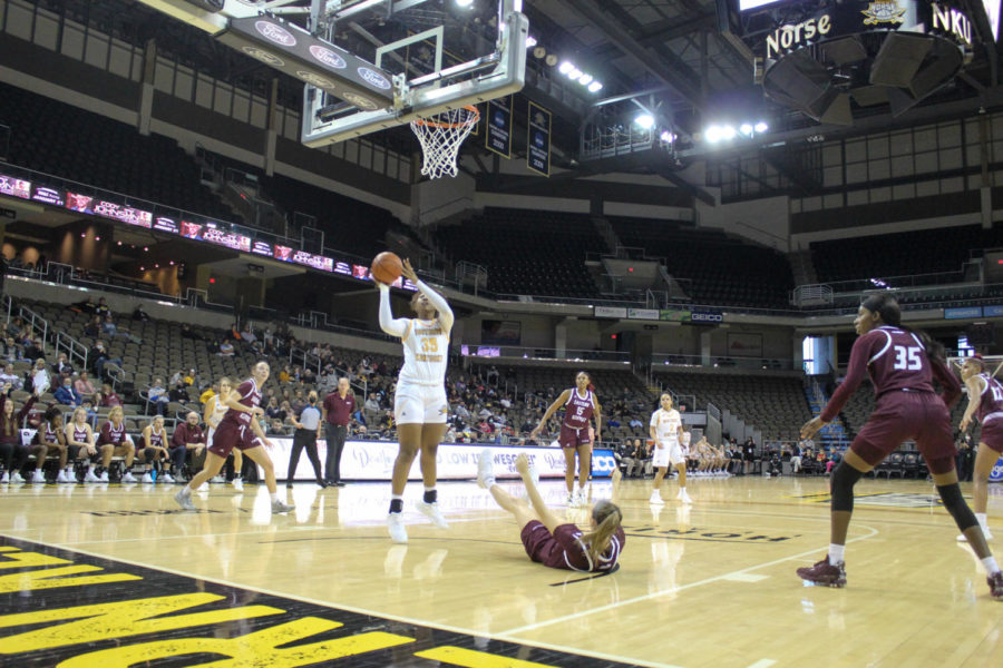 NKU forward Trinity Thompson (35) finishes a layup as her defender drops to the ground on Sunday.