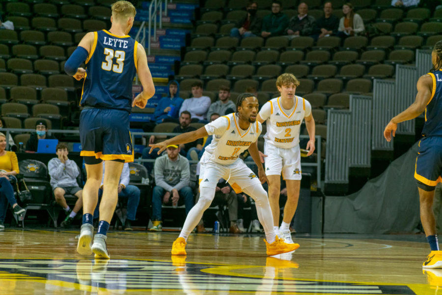 NKU guard Bryson Langdon (11) defends at the top of the key against UNC Greensboro.