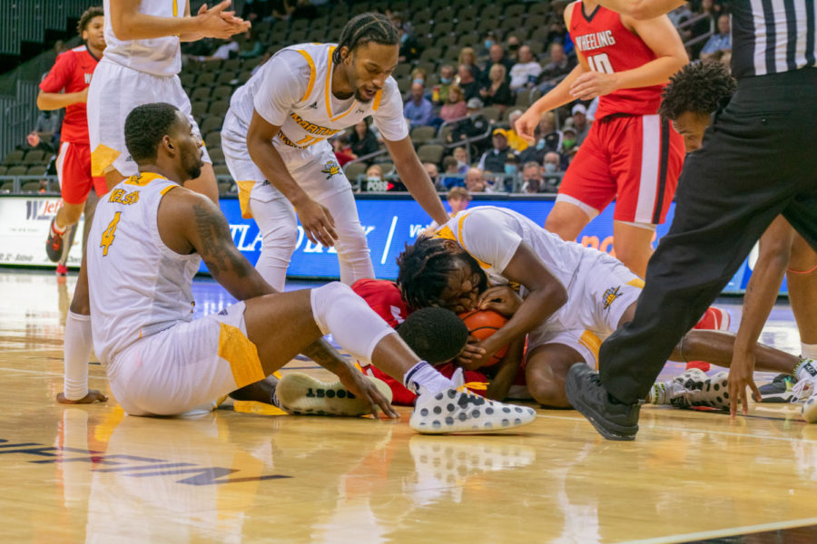 The Norse and Cardinals fight for a loose ball on Tuesday night. NKU won 82-54.