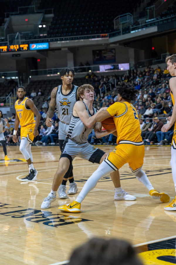 NKU guard Sam Vinson battles with a Canisius player for the ball on Wednesday night at BB&T Arena.