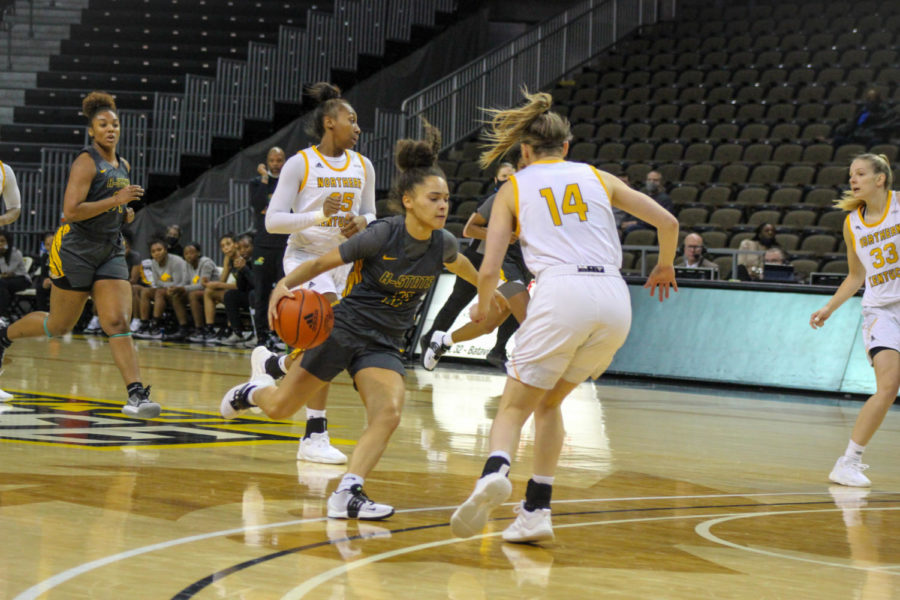 NKU guard Kennedy Igo (14) guards a Kentucky State player as she drives into the lane on Wednesday at BB&T Arena.