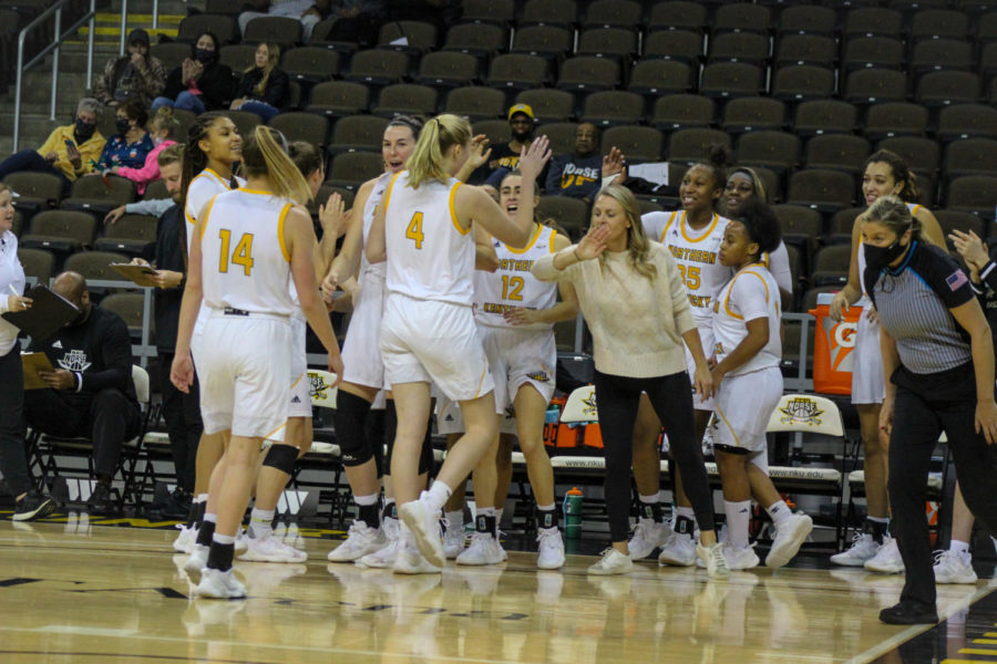 NKU players celebrate a basket before the halftime break by forward Paige Hodgson (4). 