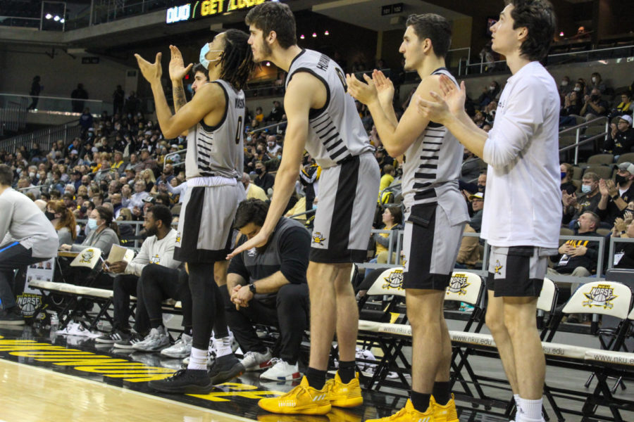 The NKU mens basketball team celebrates on the bench during the 79-74 win for the Norse.