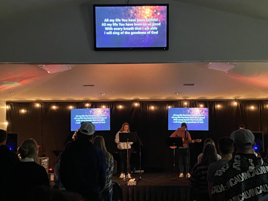 Students sing songs of praise during a worship service at the Baptist Student Center on Tuesday.