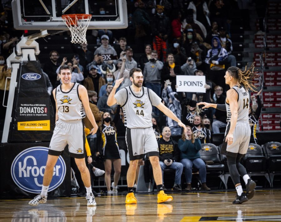 NKU forward David Wassler (44) celebrates with teammates after hitting a three in the final minute on senior night.