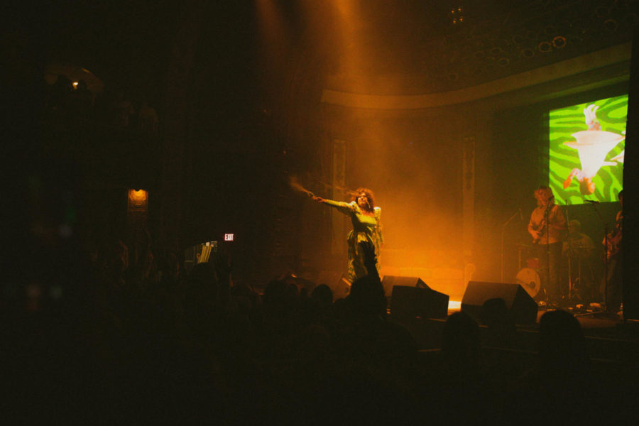 Remi Wolf throwing water on fans.