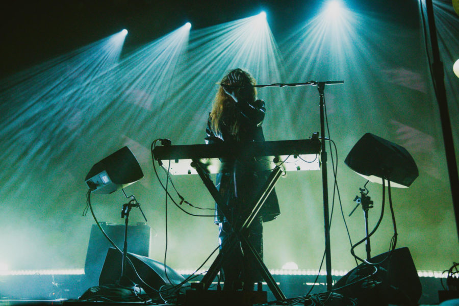 Light shines behind Victoria Legrand and she sings into the mic.