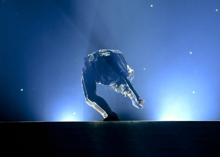 Billie Eilish shows off her flexibility while performing in Louisville, KY.