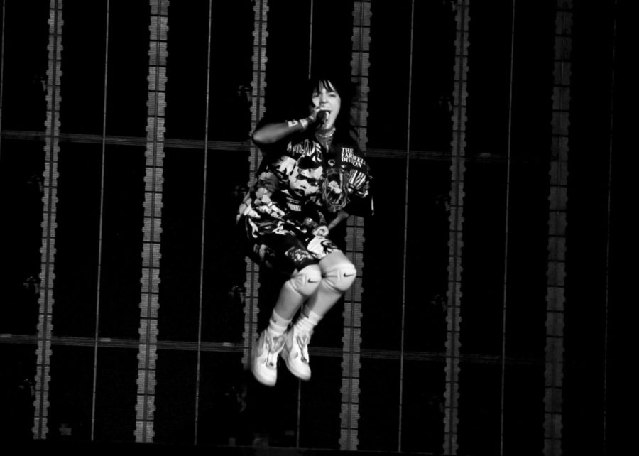 Eilish jumps as she sings the words to her hit song "Therefore I Am".