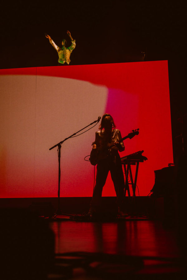 Conan Gray opening the show on top of his set, peering down at all of the fans.