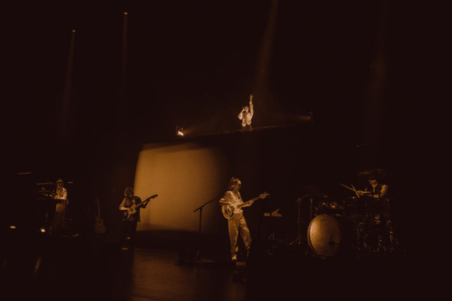 Conan Gray accompanied by his band members on stage at the Andrew J. Brady Music Center.