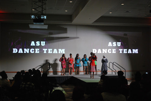 Event executive board gathers on stage to conclude the event. 