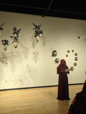 Mariam Shaban reading her speech at the artist talk during the Juried Student Exhibition opening ceremony.