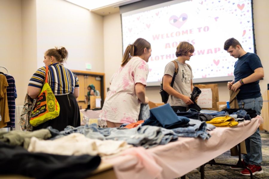 Students trading clothes at the Alpha Omicron Pi clothing swap event. 