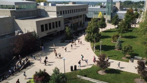 Students walk across the Northern Kentucky University Campus plaza.