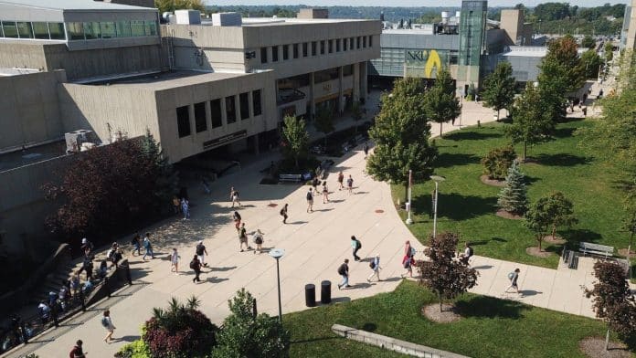 Students walk across the Northern Kentucky University campus plaza.