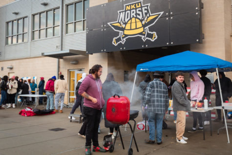 Students gathered outside the soccer complex adjacent to Truist Arena, setting up awnings and grilling before the game against UC.