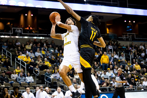 Trey Robinson makes an effort towards the basket while being guarded by the Panthers’ Vin Baker Jr. The junior guard continued a string of phenomenal games with 18 points and a team high four steals on the night.