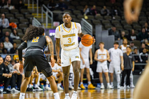 Marques Warrick surveys the floor as he is defended by Purdue Fort Wayne’s Damian Chong Qui (2) in the first half of NKU’s 74-54 win Saturday night. Warrick led the Norse in scoring for the third consecutive game as the junior guard posted 18 points in the winning effort.