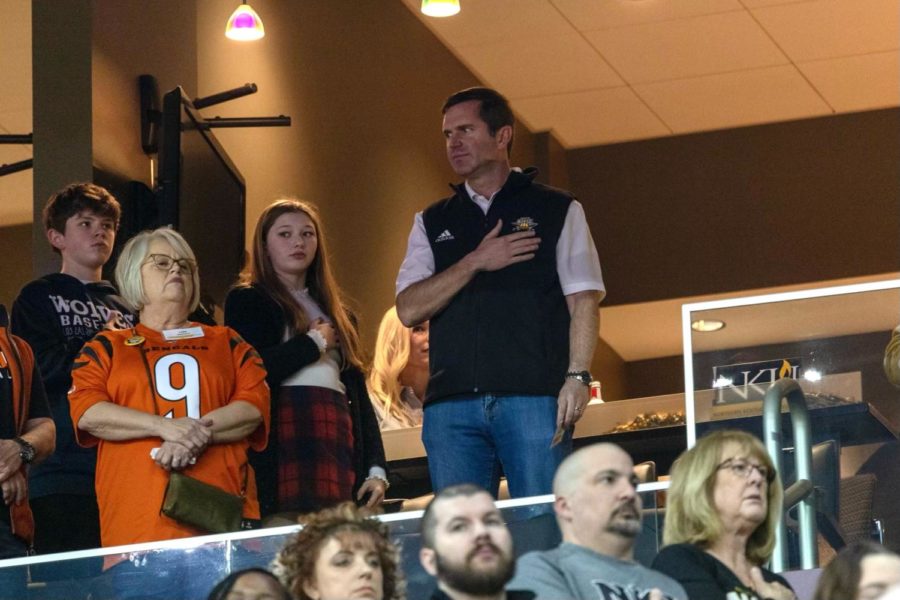 Gov. Andy Beshear stands for the National Anthem at Truist Arena on Jan. 28.