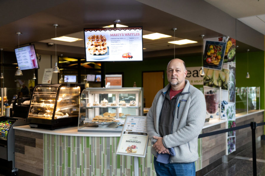 Marty Meersman in front of some of the waffles that you can now enjoy in the Student Union.