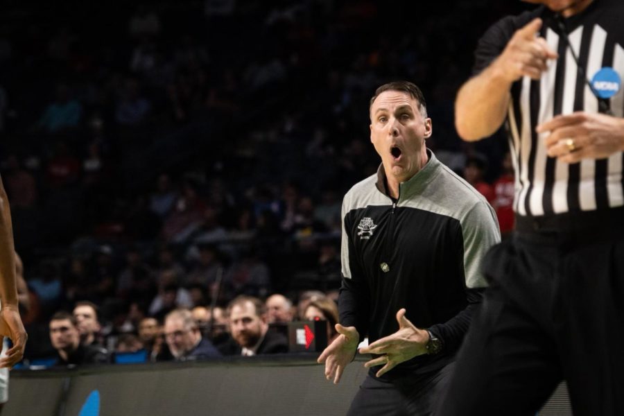 Coach Darrin Horn makes a surprised reaction to a play in a basketball game.