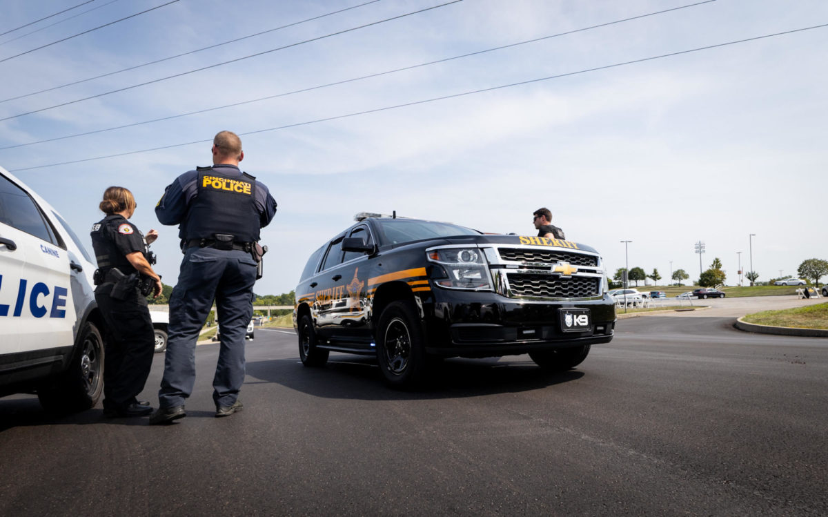 Police officers surround University Drive while investigating a suspicious package Monday morning.