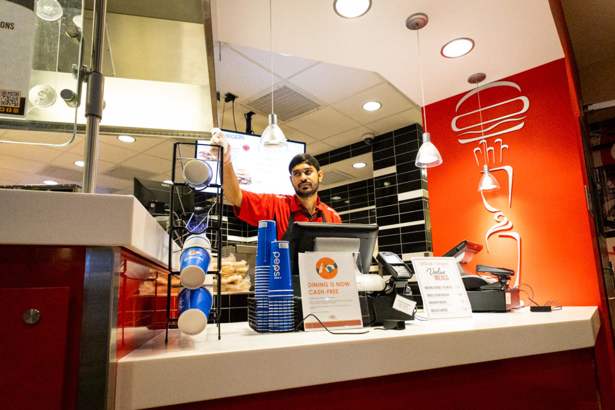 An employee at Steak n Shake waits to take an order.