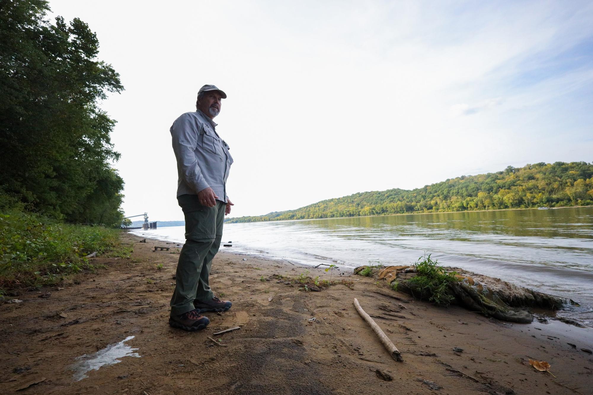 Dr. Richard Durtsche stands on the bank of the Ohio River in St. Anne Woods and Wetlands.