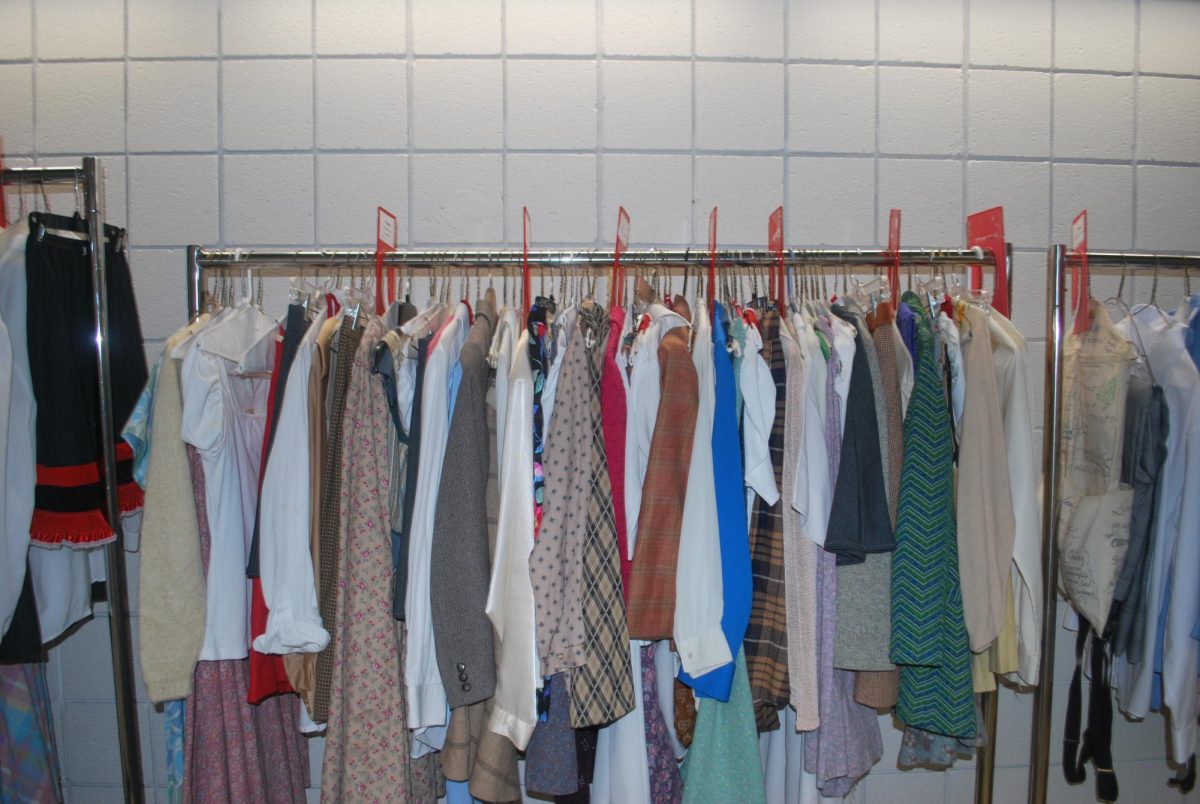 Costumes for  “9 to 5: The Musical” hang in a Fine Arts Center hallway.