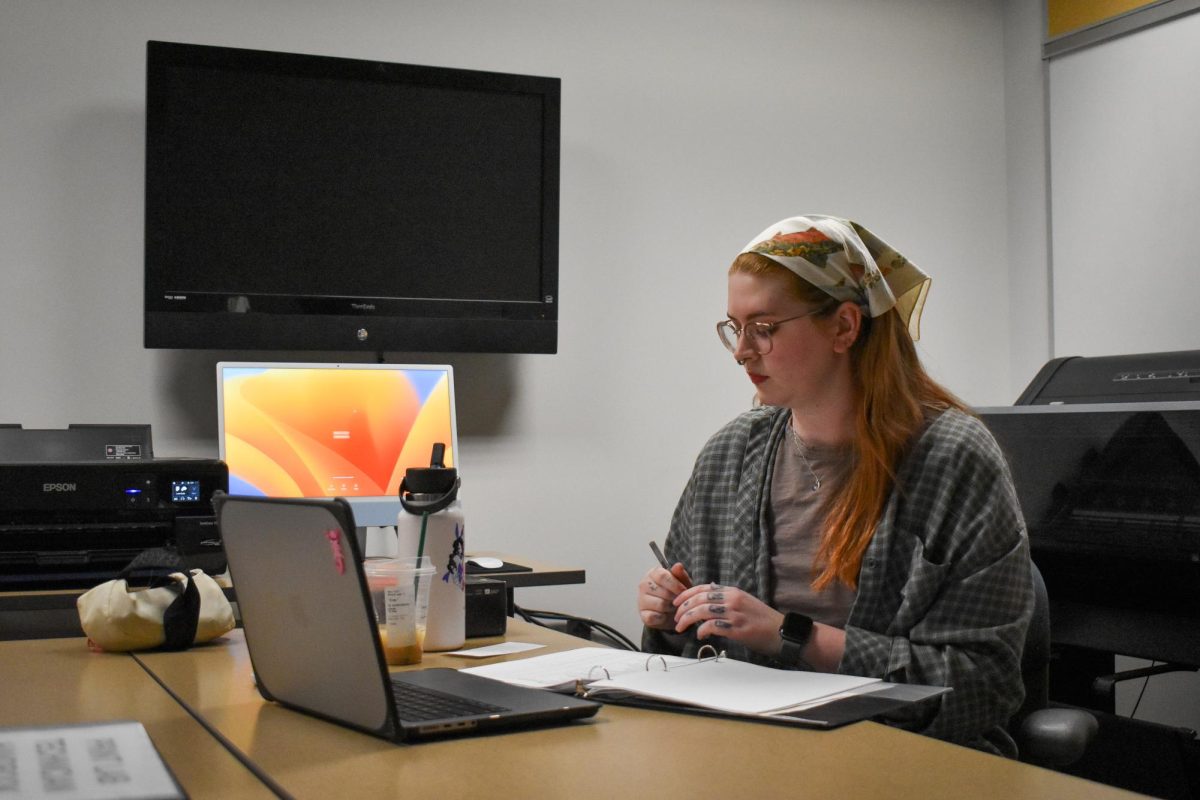 Senior Evey Cooper in the print labs temporary space in the library 