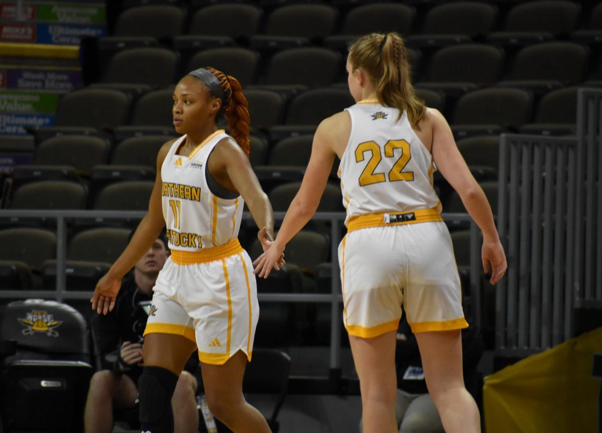 Junior Khamari Mitchell-Steen (left) high-fives teammate Noelle Hubert during Fridays match-up against Oakland.