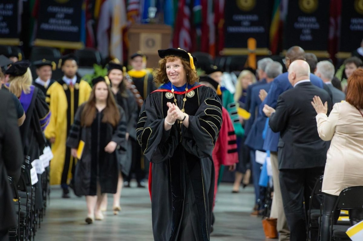 Dr. Cady Short-Thompson exits the presidential installation in Truist Arena on Friday.