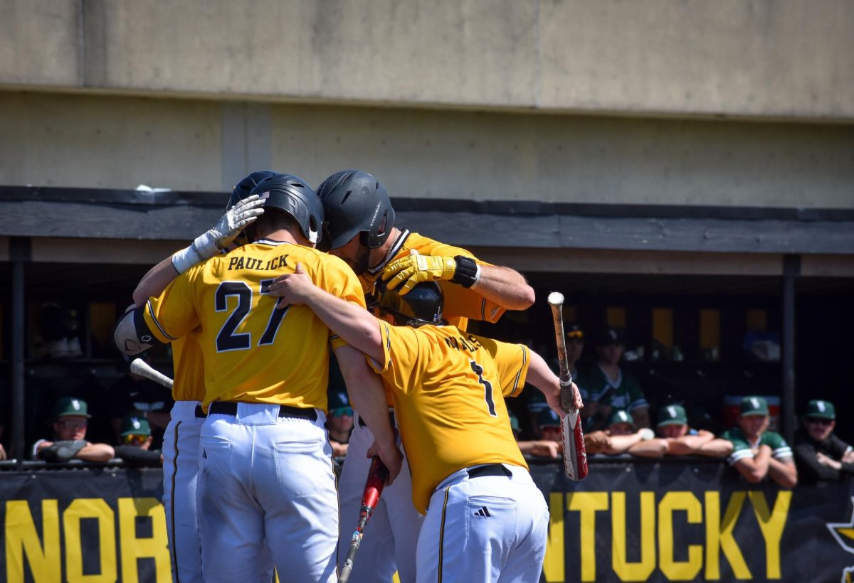 Graduate student and outfielder Treyvin Moss celebrities with teammates after a home run to start the first inning.