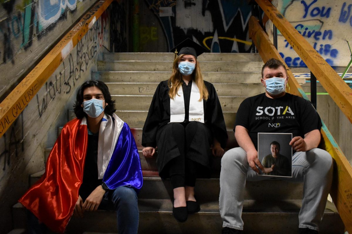 (Left to right): Stefano Pecile, Madison Fulton and Noah Warner prepare to walk across the stage at NKUs commencement on May 5.